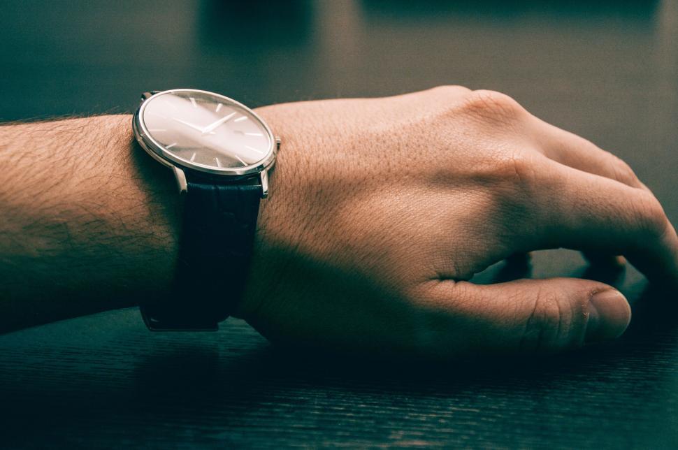Free Image of Close-up of a wristwatch on a person s wrist resting. 