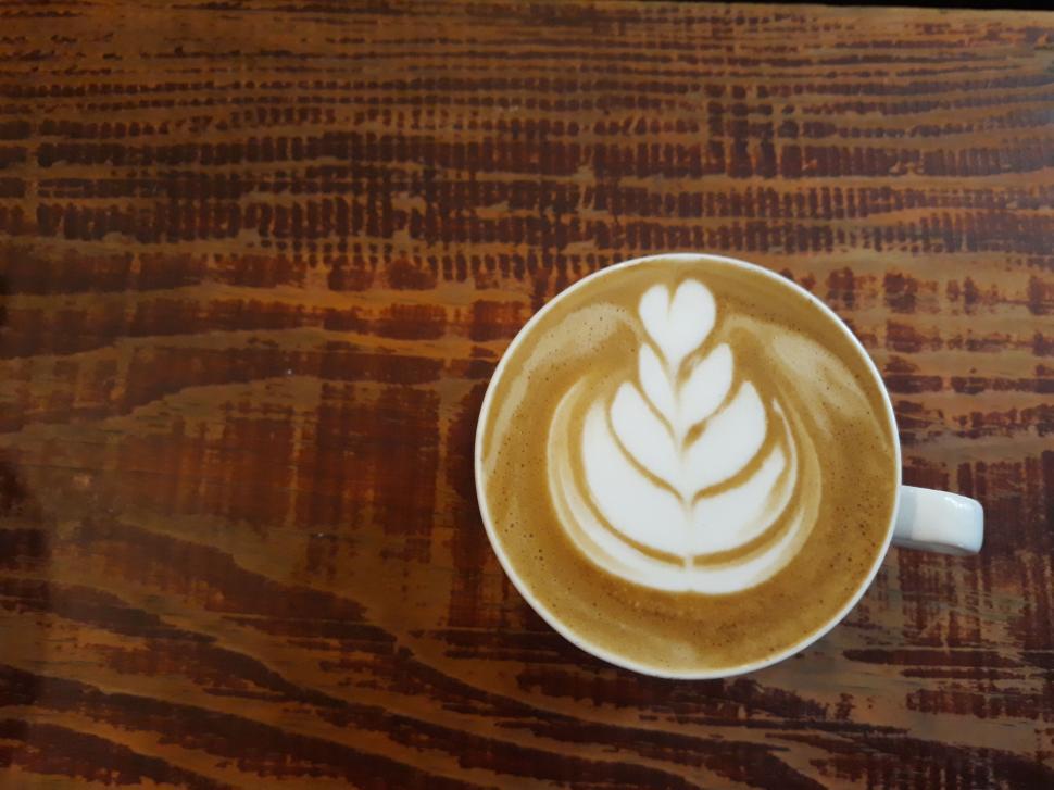 Free Image of Delicate latte art served on a wooden table. 