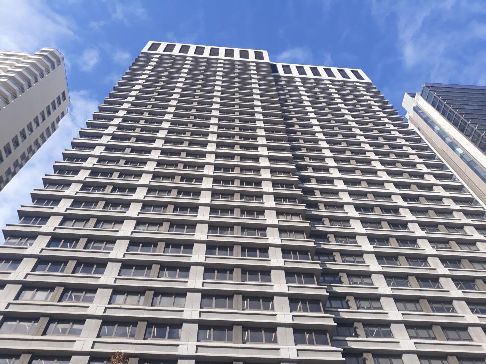 Free Image of Tall modern skyscraper against a blue sky. 