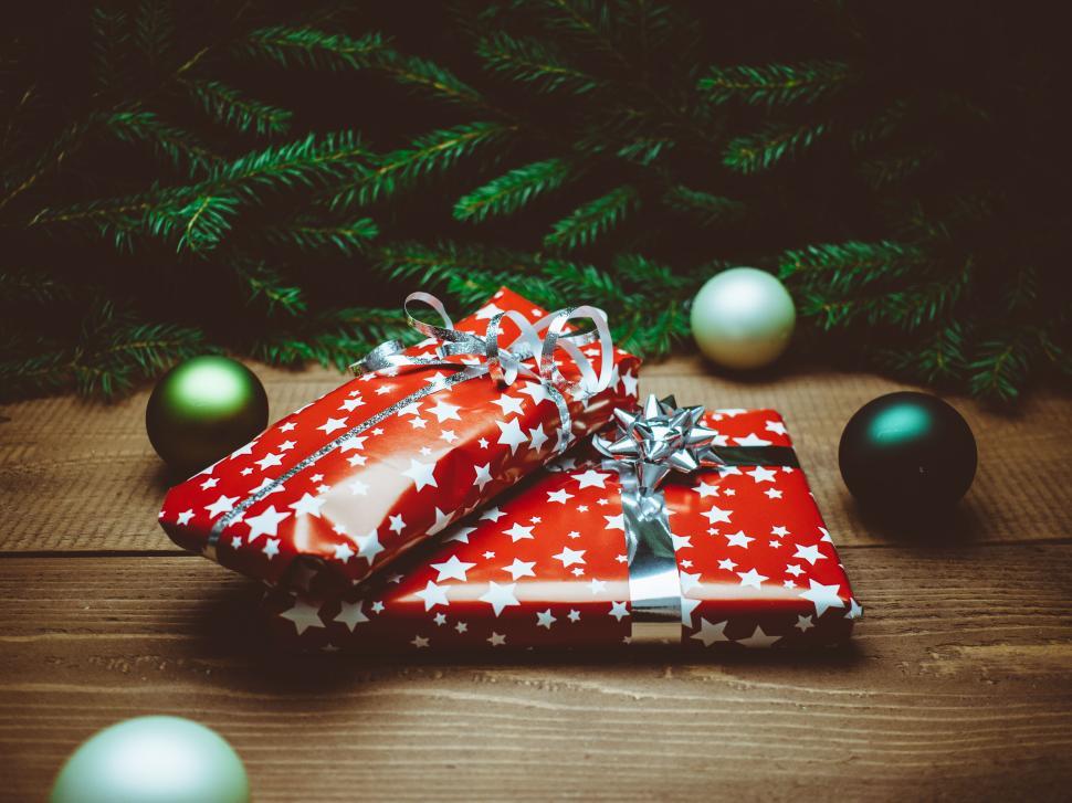 Free Image of Christmas gifts wrapped in red starry papers. 