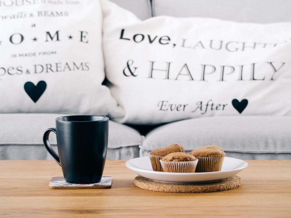 Free Image of Coffee mug and muffins on a wooden table at home 