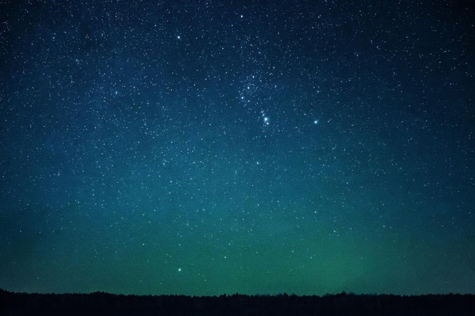 Free Image of Starry night sky with a horizon barely visible below. 