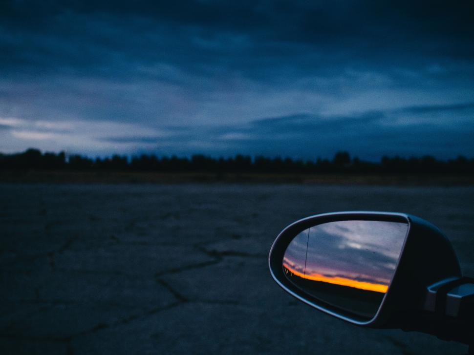 Free Image of Car mirror reflecting a stunning colorful sunset sky 
