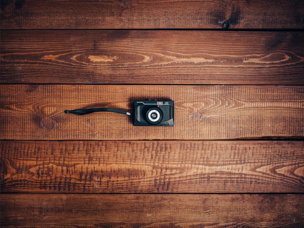 Free Image of Vintage camera against wooden background on the table. 