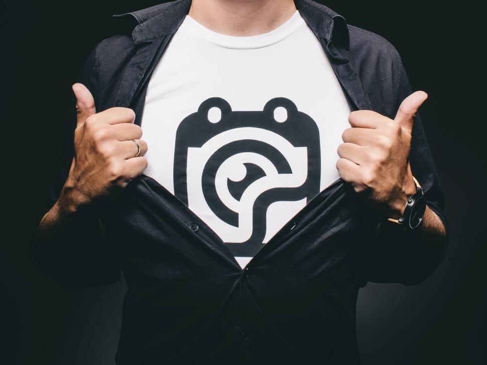 Free Image of Man revealing a shirt with a bold, abstract design. 