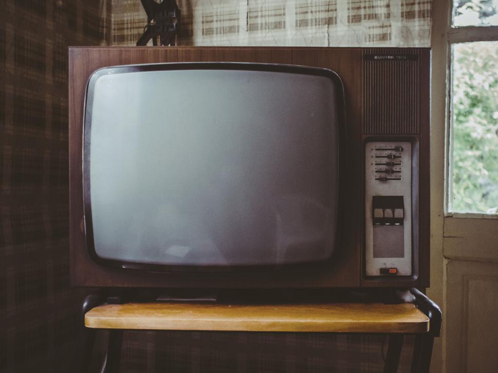 Free Image of Vintage television set on wooden stand, nostalgic scene. 