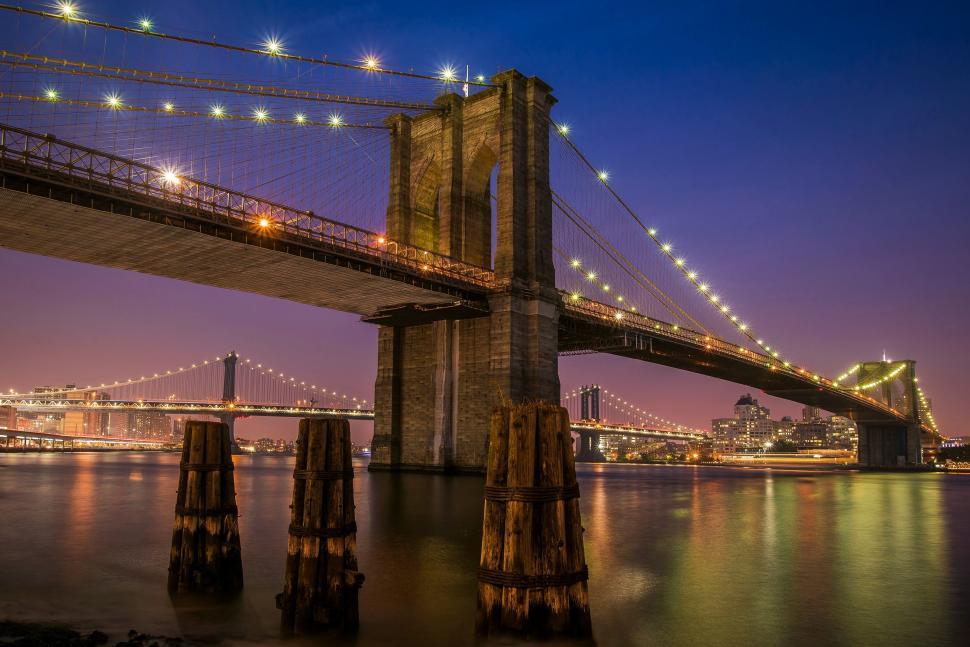 Free Image of Brooklyn Bridge at twilight with reflected lights. 