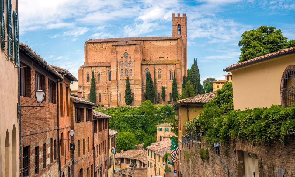 Free Image of Historic building with red brick facades and greenery. 