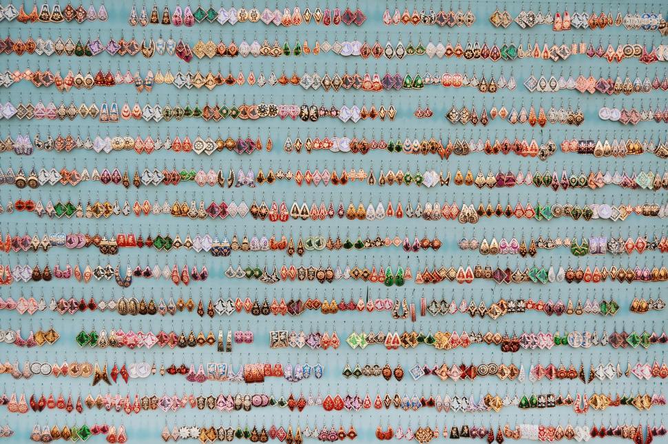 Free Image of Colorful handcrafted earrings displayed in neat rows. 