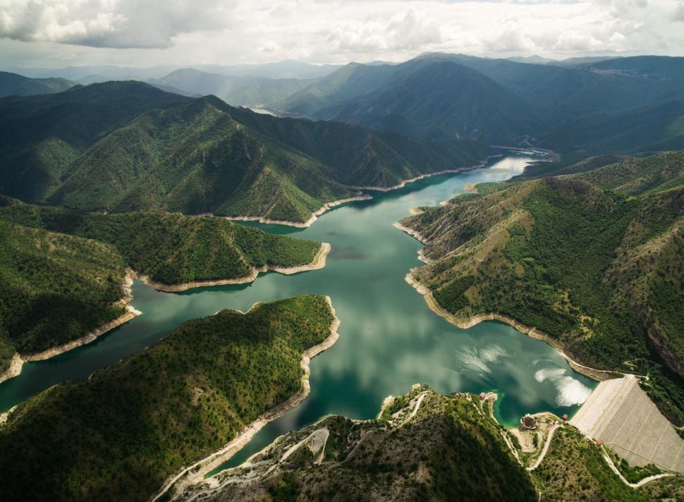 Free Image of Aerial view of green valley and river through mountains. 