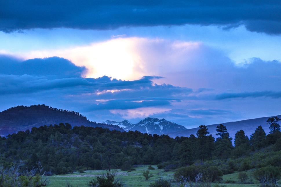 Free Image of Stormy sky over a mountain range with dramatic clouds. 