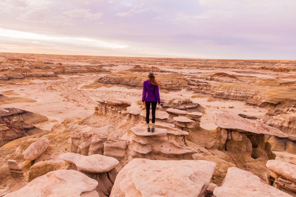 Free Image of Woman exploring desert landscape filled with rock formations. 