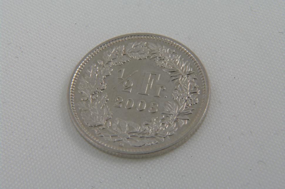 Free Image of Silver Coin on White Surface 