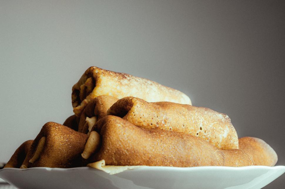 Free Image of Plate of appetizing crepes stacked up ready for serving. 