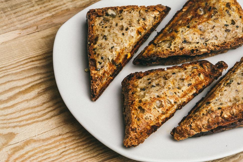 Free Image of Toasted triangles of bread with seeds on white plate 