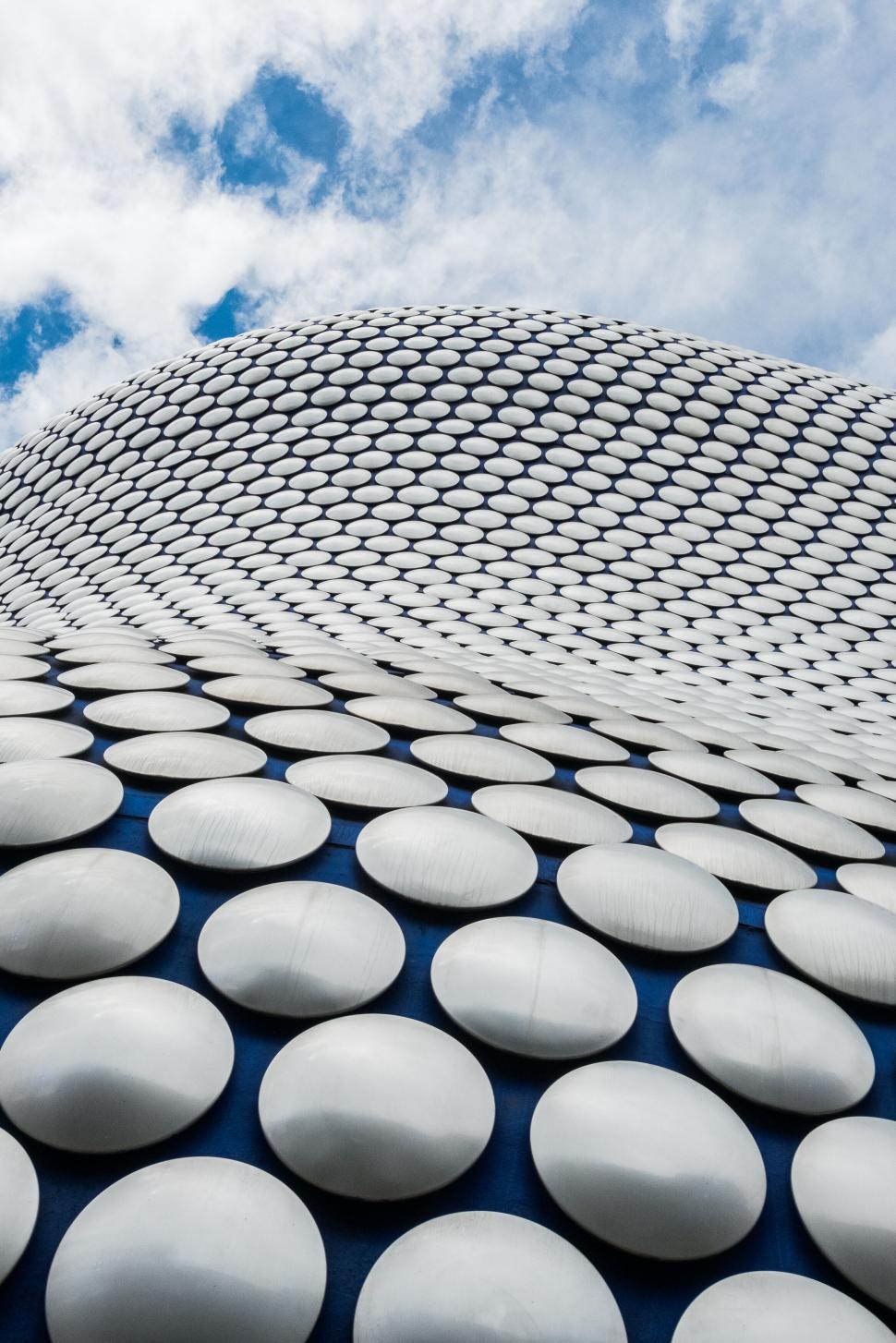 Free Image of Curved modern architectural building with circular panels. 