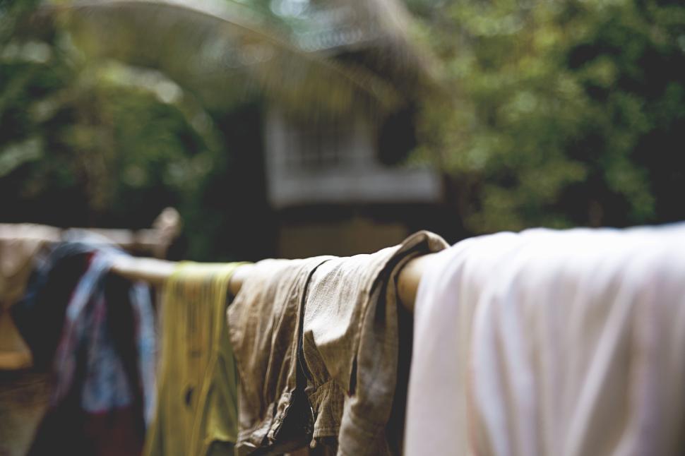Free Image of Clothes hanging on a line outside in a rural setting. 