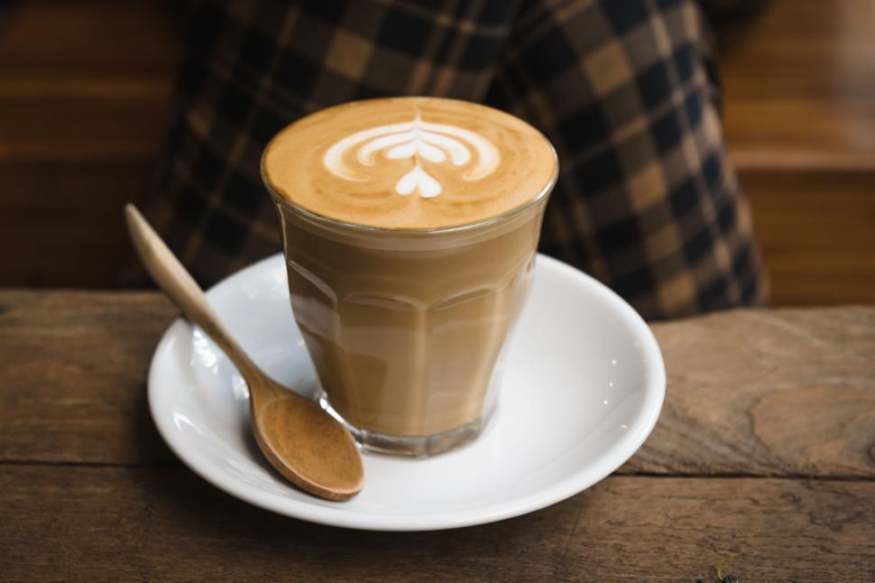 Free Image of Latte with heart-shaped foam in cozy cafe setting 