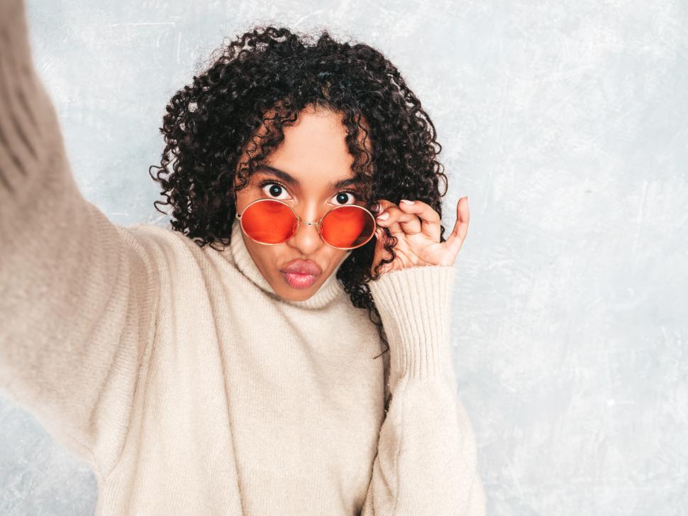 Free Image of Person taking a selfie in a cozy cream sweater 