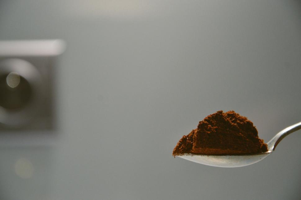 Free Image of Spoonful of ground coffee ready for brewing morning cup. 