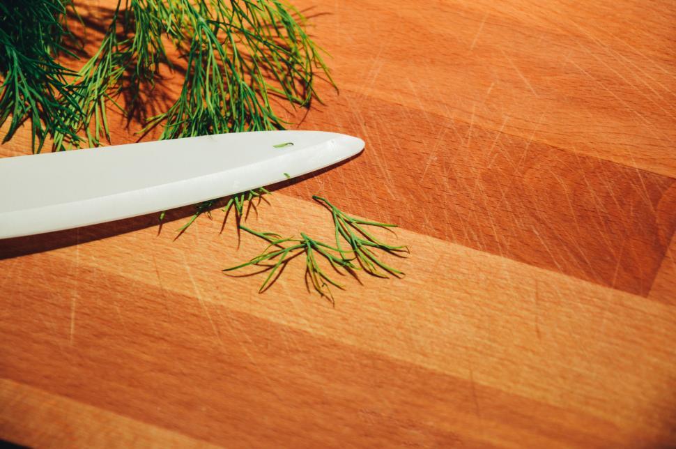 Free Image of Fresh dill and knife on wooden cutting board close-up 