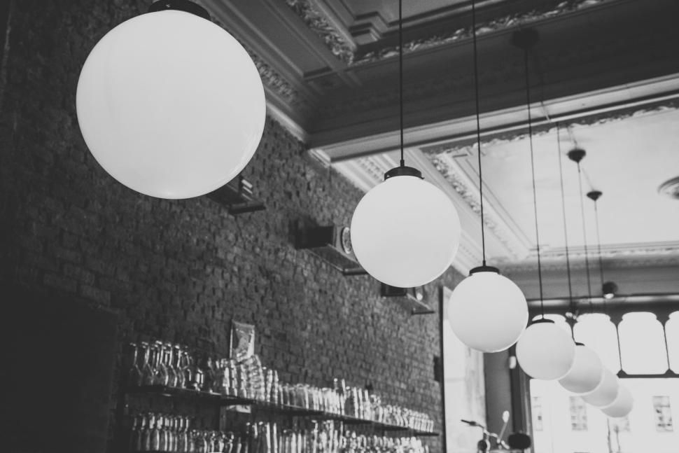 Free Image of Large spherical light fixtures hanging in a rustic cafe 