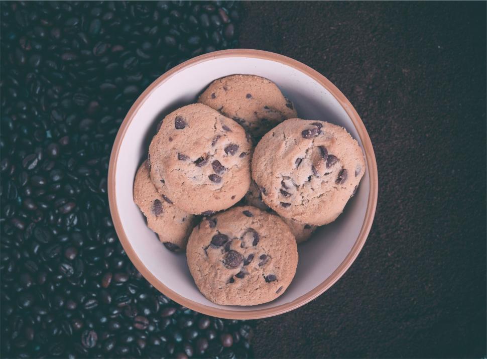 Free Image of Bowl of chocolate chip cookies on coffee beans 