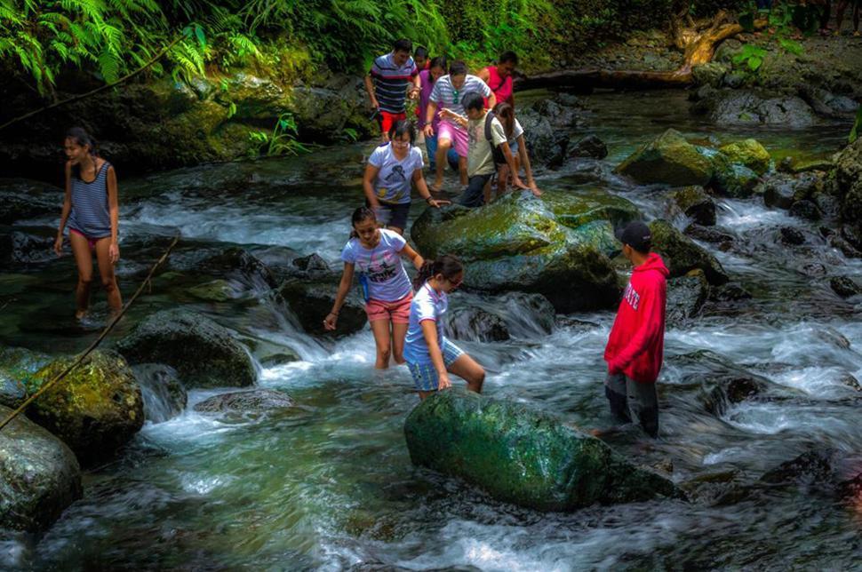 Free Image of People enjoying a natural stream in a scenic environment 
