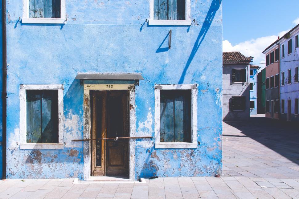 Free Image of Old blue building with worn textures in empty street 