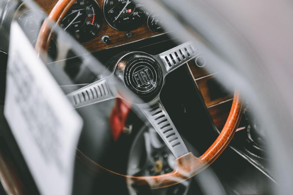 Free Image of Vintage car steering wheel and dashboard close-up shot. 