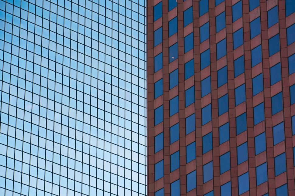 Free Image of Geometric contrast between blue and red office buildings. 