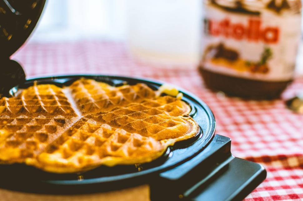 Free Image of Golden, crispy waffles in an electric waffle maker. 
