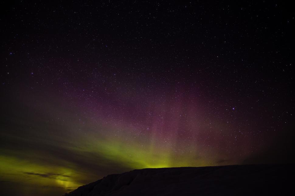 Free Image of Night sky with vibrant green and purple auroras 
