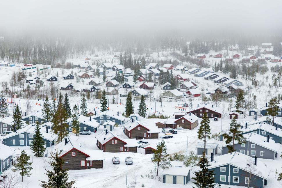 Free Image of Snow-covered village with numerous houses and trees 