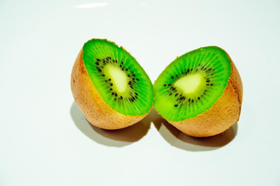 Free Image of Fresh kiwi fruit cut in half on white background 