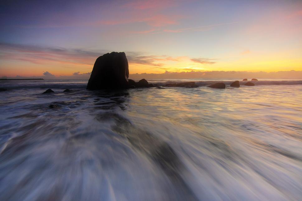 Free Image of Stormy ocean waves crashing against solid rock formations 