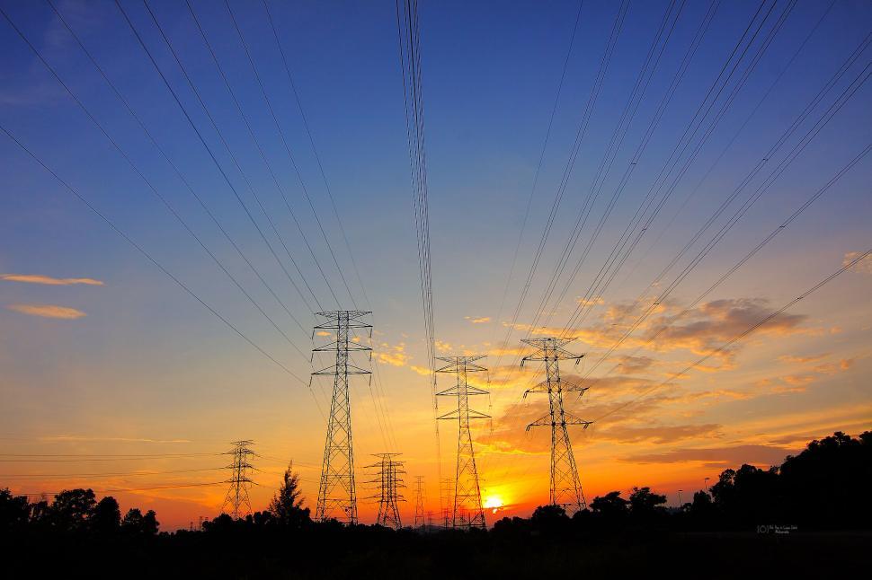 Free Image of Sunset electrical lines crossing the sky in the evening. 