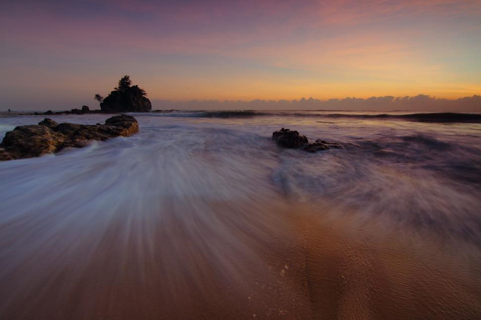 Free Image of Sunrise beach waves long exposure rocky seascape view 