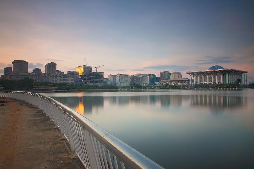 Free Image of Modern cityscape with prominent white building at sunrise. 