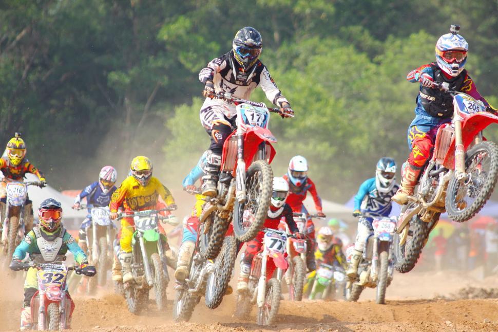 Free Image of Motocross riders competing in a high-speed race event. 