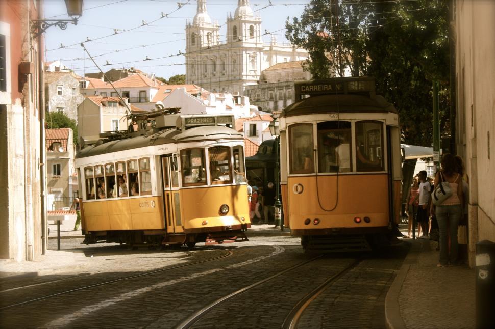 Free Image of Two vintage trams passing each other on a city street. 