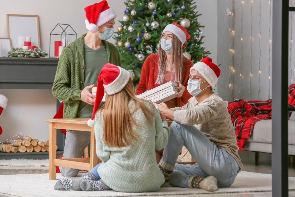 Free Image of Friends Opening Christmas Gifts and Celebrating Together. 