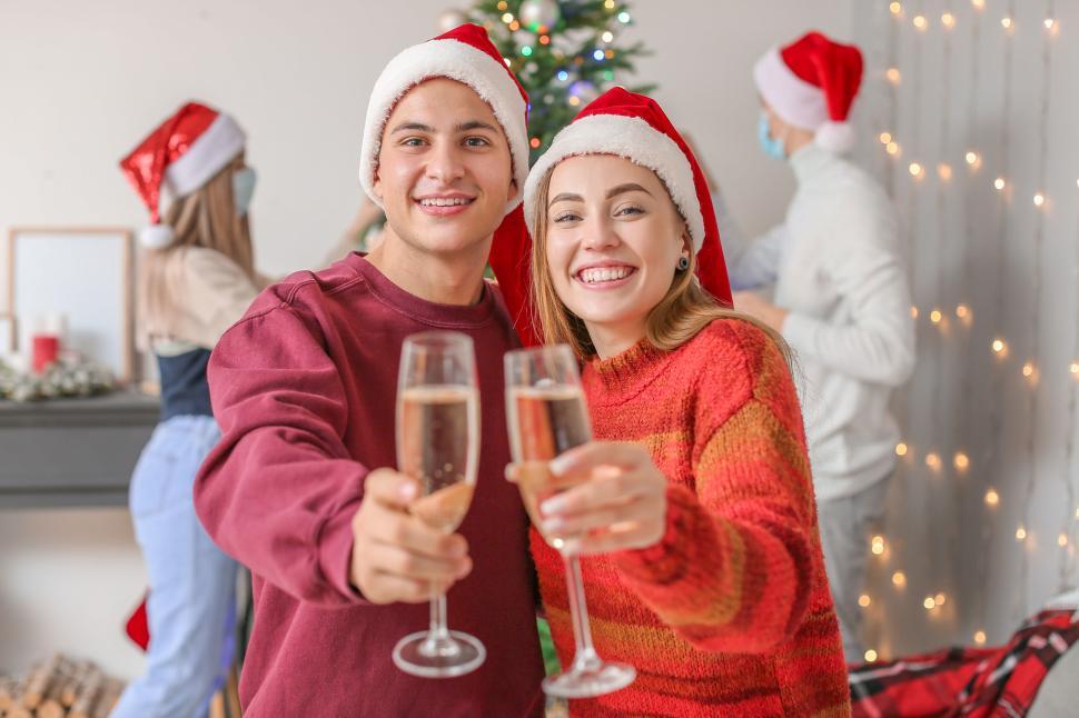 Free Image of Young Couple Celebrating Christmas with Champagne Toast. 