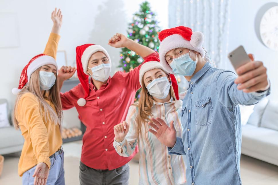Free Image of Group of Friends Celebrating Christmas While Taking Selfie. 