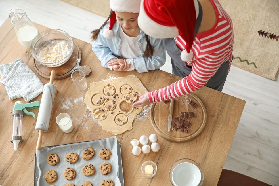 Free Image of Parent and child baking holiday cookies together 