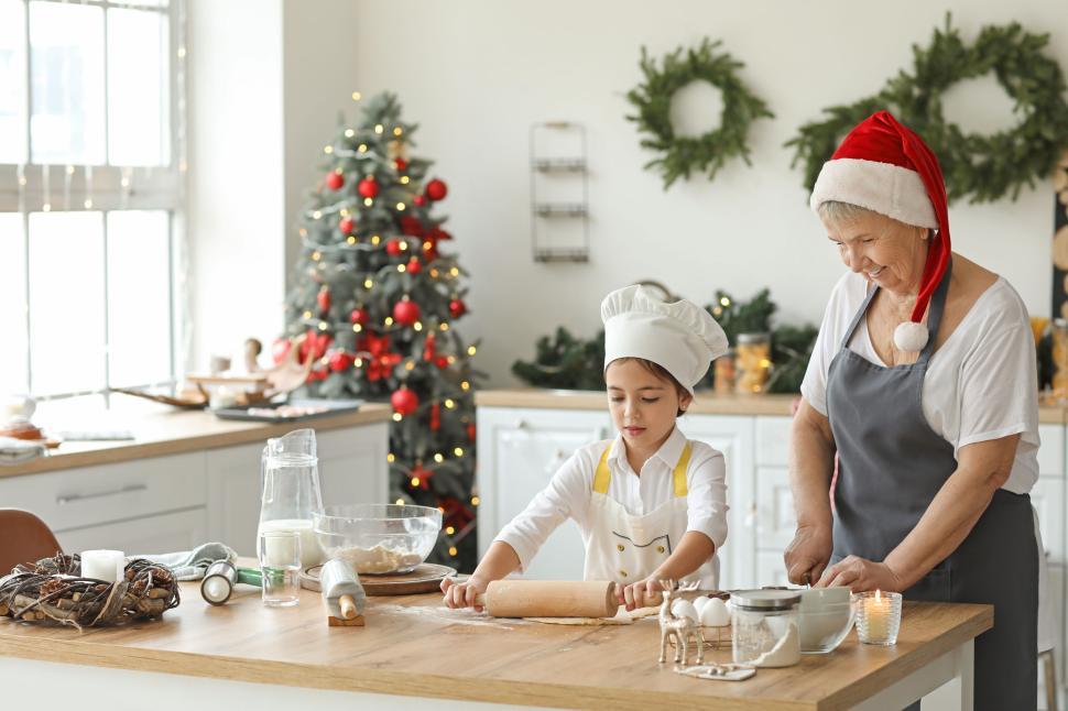 Free Image of Grandmother and child making Christmas cookies 