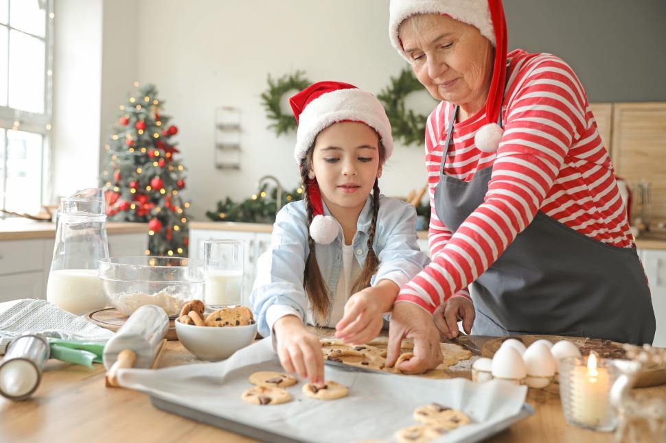 Free Image of Grandmother and grandchild baking holiday cookies 