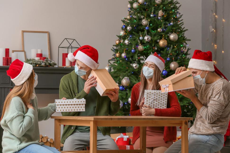 Free Image of Friends celebrating Christmas and exchanging gifts 