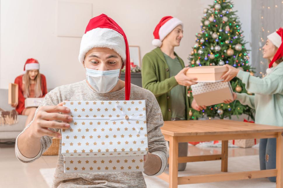 Free Image of Friends exchanging gifts during Christmas celebration 