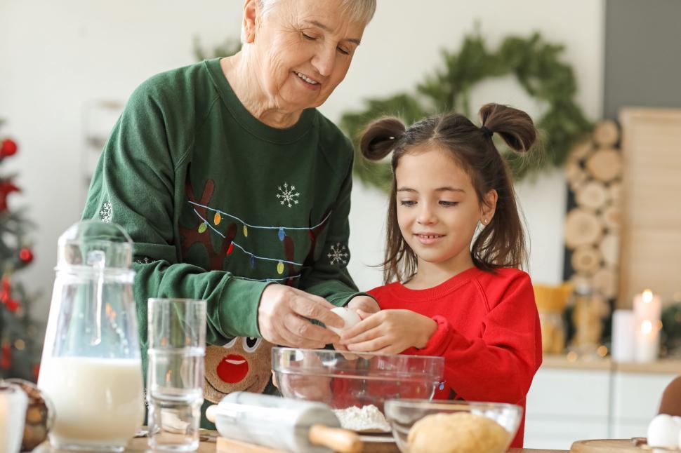 Free Image of Grandmother and granddaughter mixing flour for cookies 